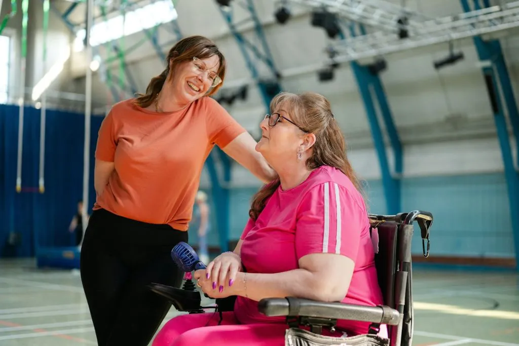 Support coordinator talking with an NDIS participant in a wheelchair